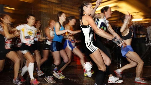 Runners in the women's elite division jockey for position as they sprint off the starting line towards a stairwell at the start of the 2011 Empire State Building Run-Up.