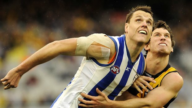North Melbourne's Hamish McIntosh battles with Tiger Tyrone Vickery.