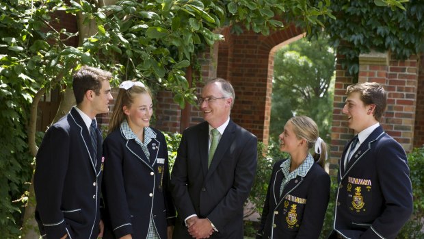 Principal Peter Miller, with secondary students, says everyone benefits when schools share ideas.