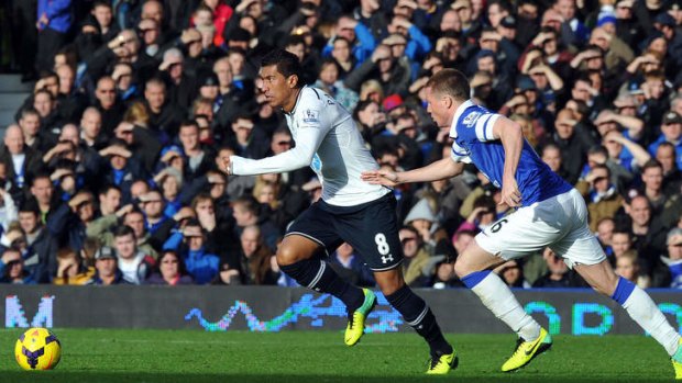Stalemate: Tottenham Hotspur's midfielder Paulinho is chased by James McCarthy.