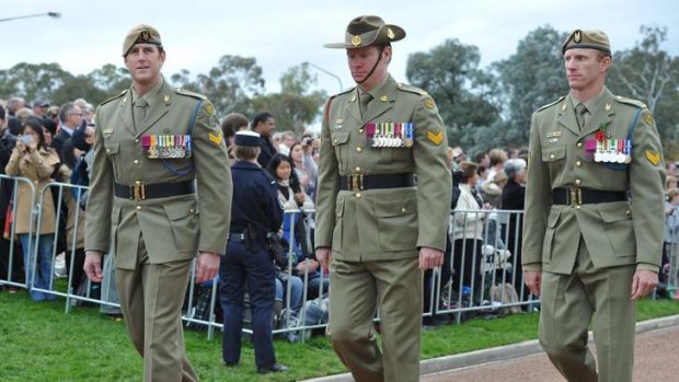 Marching are VC recipients (from left) Ben Roberts-Smith, Daniel Keighran and Mark Donaldson.