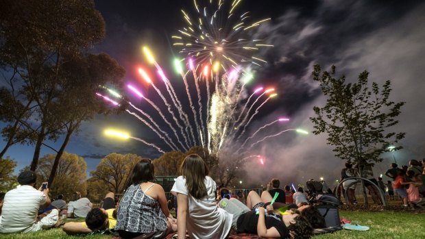 Families watch the fireworks. 