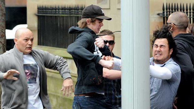 A fight breaks out between supporters of Todd Burrows and Jay William Cook at St James Court in Sydney.
