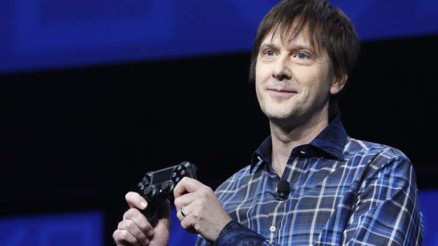 PlayStation 4's lead system architect Mark Cerny holds a gaming control device during the unveiling of the PlayStation 4 launch event in New York.