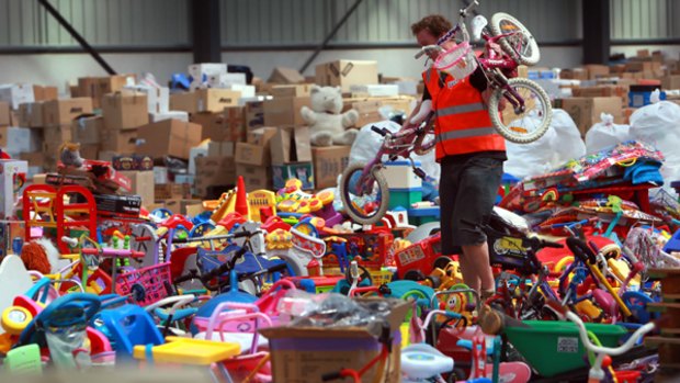 Gift mountain...  Damon Maguire sorts through a mountain of donated toys at the Rowville Vinnies warehouse.