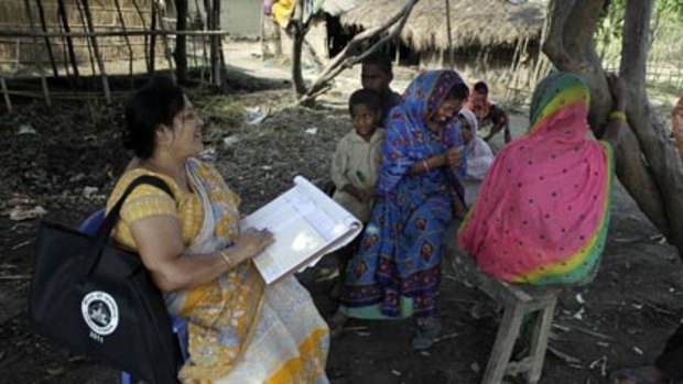 Census worker Mridula Brua collects information from the Budhia Shah family in Assam, northern India.