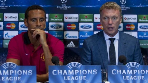 Costly reign: David Moyes with Rio Ferdinand at a Champions League news conference last year. Manchester United failed to qualify for the competition next season.