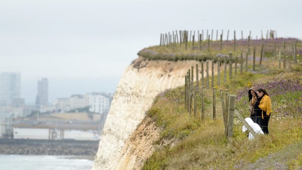 People lay flowers at the clifftop where Arthur Cave fell to his death.