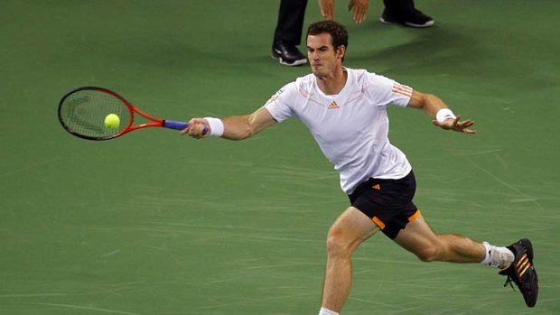 Andy Murray hits a return to Roger Federer during their semi-final.