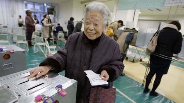 One vote ... a woman casts her ballot at a polling station in Tokyo.