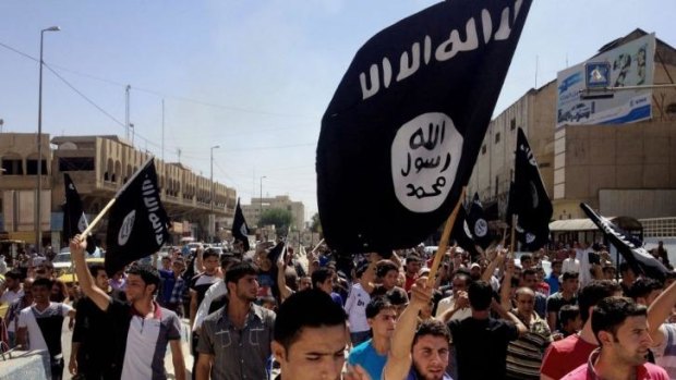Demonstrators march in support of the Islamic State of Iraq and the Levant in Mosul.