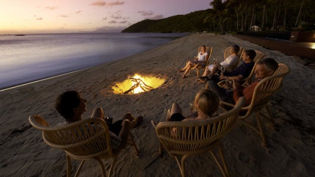 Guests sit on the beach at Orpheus Island.