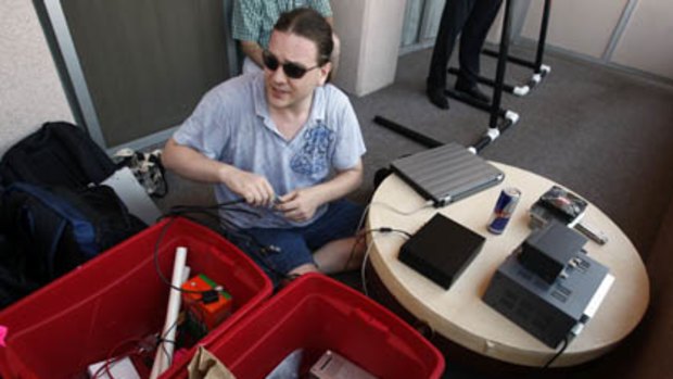 Hacker Chris Paget sets up a long range RFID reading device at the DefCon hacker conference in Las Vegas.