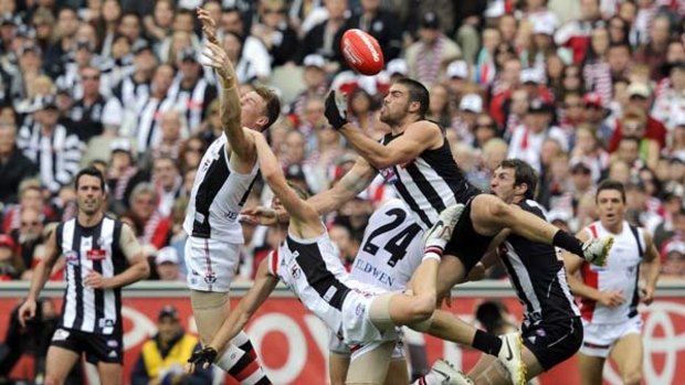 Magpie forward Chris Dawes has plenty of company as he tries to take a mark.