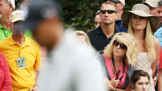 Lindsey Vonn watches as boyfriend Tiger Woods plays the first hole.