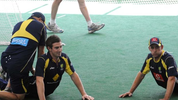 Limbering up ... Shaun Marsh and Michael Hussey stretch muscles before a batting session at the MCG nets. Marsh is still battling a back injury that leaves him unlikely to play in the Boxing Day Test.