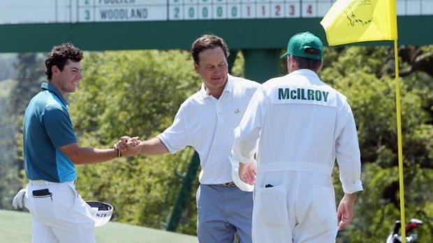 McIlroy of Northern Ireland shakes hands with marker Jeff Knox on the 18th green.