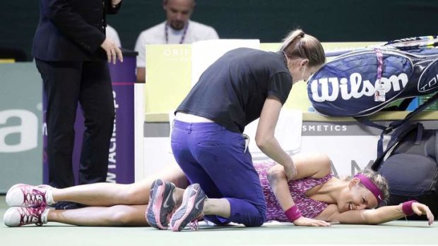 All pain no gain: Victoria Azarenka of Belarus received treatment to her injured back during her loss to Li Na.