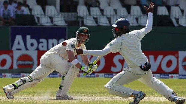 Close call: Phillip Hughes beats the diving Lahiru Thirimanne on his way to a century.