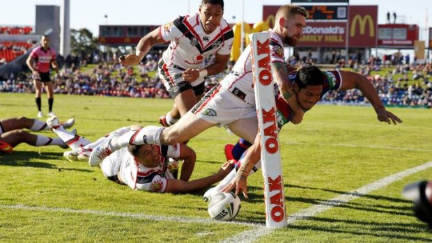 Barely there: Sione Mata’utia scores on Sunday.