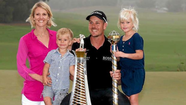 Rich pickings: Henrik Stenson with his family on the 18th green after winning the Race to Dubai.