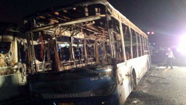 The remains of an express bus that burst into flames in Xiamen, southeast China's Fujian Province on Friday, June 7, 2013. The express bus burst into flames on an elevated road in southeastern China on Friday, killing at least 30 people and injuring more than 30, state media reported.