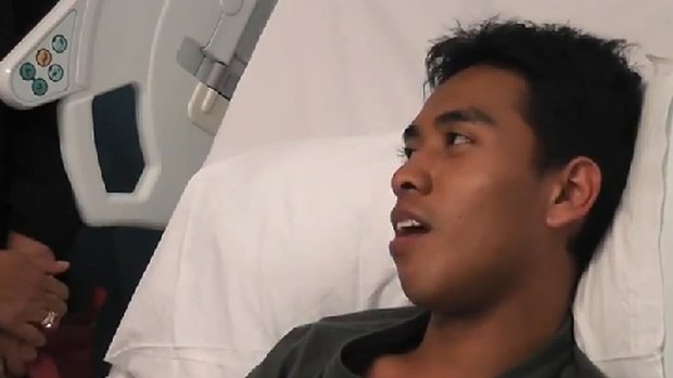 Broken jaw, smashed teeth ... Ashraf Haziq speaks from his hospital bed in a video posted on YouTube.