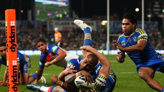 Finishing touch ... winger Akuila Uate scores a vital try for the Knights against Parramatta last night.