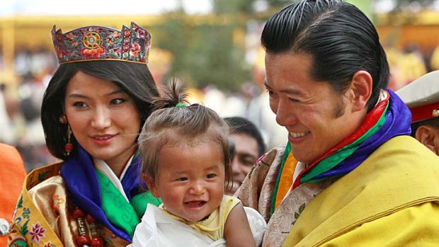 Just married ...King Jigme Khesar Namgyel Wangchuck, right, holds a young child as he greets locals with his new Queen.