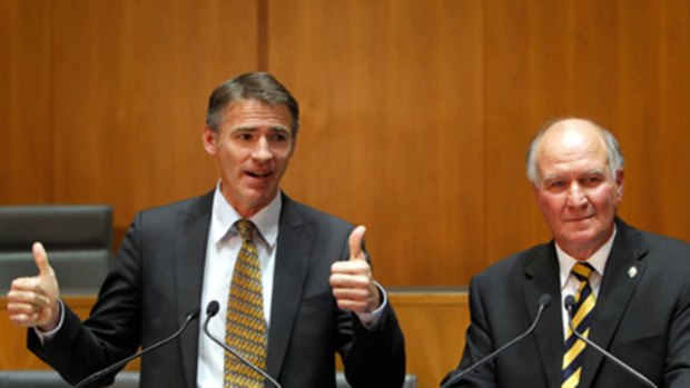 Thumbs up for Labor ... Rob Oakeshott and Tony Windsor give their support to Julia Gillard.