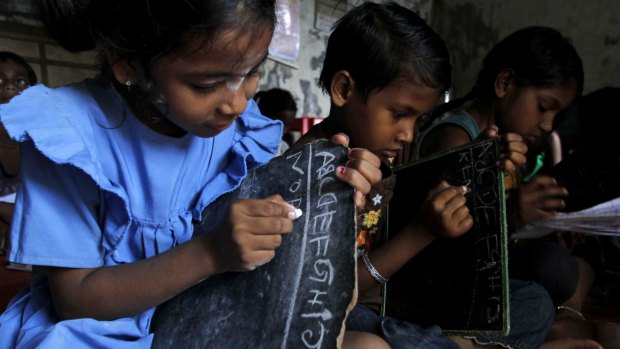 Impoverished children study at a school in Bhubaneswar, India, run by a social organisation. 