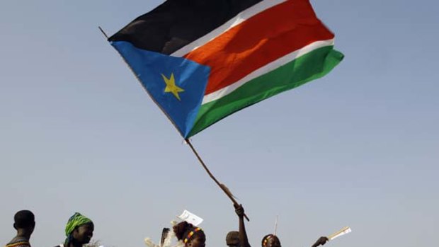Chance for change ... a woman raises the southern Sudanese flag at a pro-independence rally.