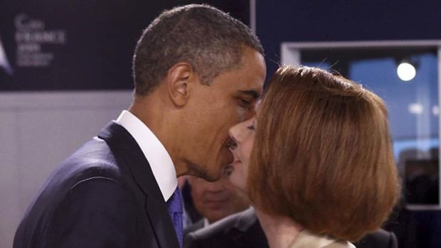 US President Barack Obama kisses Australia Prime Minister Julia Gillard.