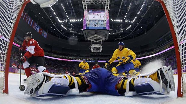Canada's Sidney Crosby (87) scores on a breakaway past Sweden's goalie Henrik Lundqvist during the second period.
