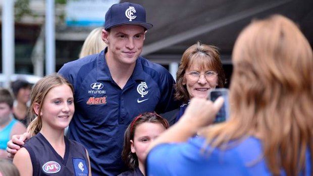 Mitch Robinson with some Carlton fans during the Blues' visit to Lygon street on Monday.