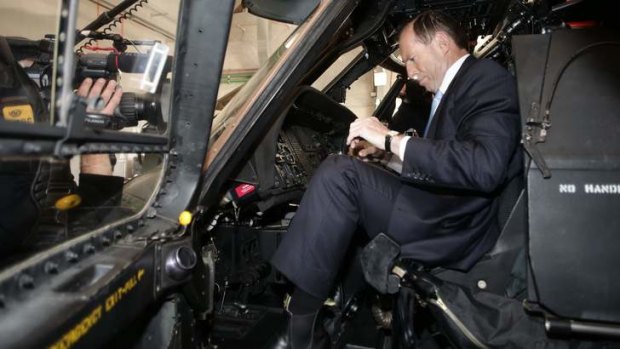 Coalition leader Tony Abbott inspects a Blackhawk helicopter during his visit to Holsworthy Barracks in NSW on Monday.