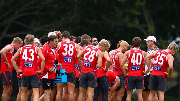 Swans coach John Longmire talks to his players during a training session at Lakeside Oval on Thursday.