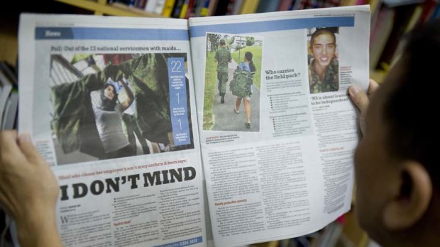 The controversial photo of a maid carrying a soldier's bag for him appeared in the Singapore press.