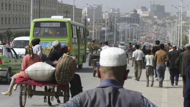 Road works ... carts, cars and buses head into Kashgar, Xinjiang.