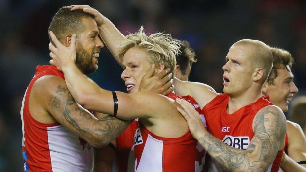 MELBOURNE, AUSTRALIA - MAY 14: Lance Franklin of the Swans with Isacc Heeney and Zak Jones (R) during the round eight AFL match between the North Melbourne Kangaroos and the Sydney Swans at Etihad Stadium on May 14, 2017 in Melbourne, Australia. (Photo by Michael Dodge/Getty Images)