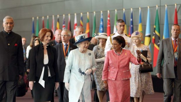 Walk and talk ... the Queen leaves the CHOGM meeting yesterday with Julia Gillard and the Prime Minister of Trinidad and Tobago, Kamla Persad-Bissessar.
