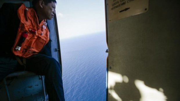 The search continues ... a military serviceman looks out of a helicopter during a search and rescue mission off Vietnam's Tho Chu island.