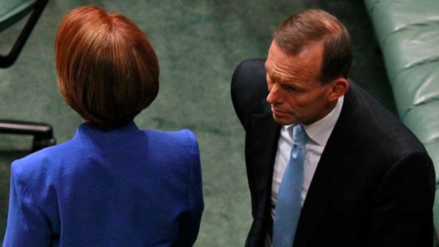 Tension ... Prime Minister Julia Gillard passes Opposition Leader Tony Abbott.
