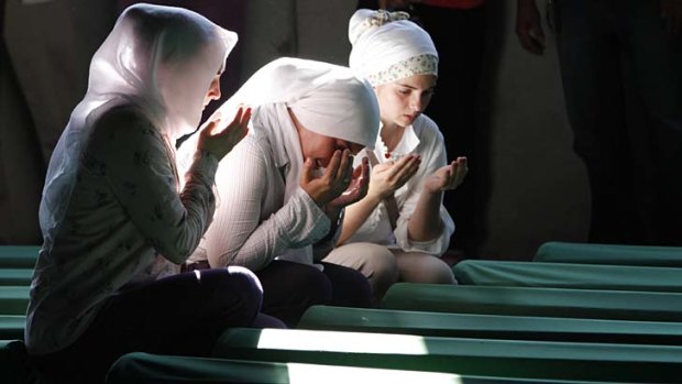 Weeping crowd &#8230; Bosnian Muslim women pray near the coffin of a relative, one of 520 identified by DNA testing almost 17 years after the Srebrenica massacre.