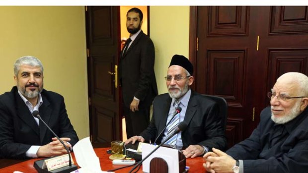 The leader of Hamas Khaled Meshaal, left, meets with Supreme Leader of the Muslim Brotherhood Mohamed Badie, centre, to congratulate him on the party's victory in the Egyptian parliamentary elections on Saturday.