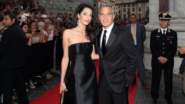Amal Alamuddin and George Clooney on their first public outing together, at the Celebrity Fight Night in Florence, Italy.