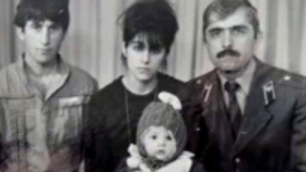 DIfferent time in their lives: an undated family photo shows Anzor Tsarnaev, left, Zubeidat Tsarnaev holding Tamerlan Tsarnaev and Anzor's brother Mukhammad Tsarnaev.