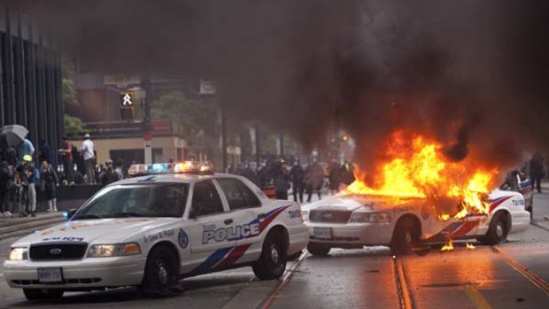 A police car burns in downtown Toronto, Canada after G20 protests turned violent.