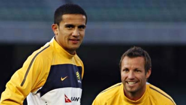 Socceroos Tim Cahill (left) and captain Lucas Neill at the MCG yesterday.