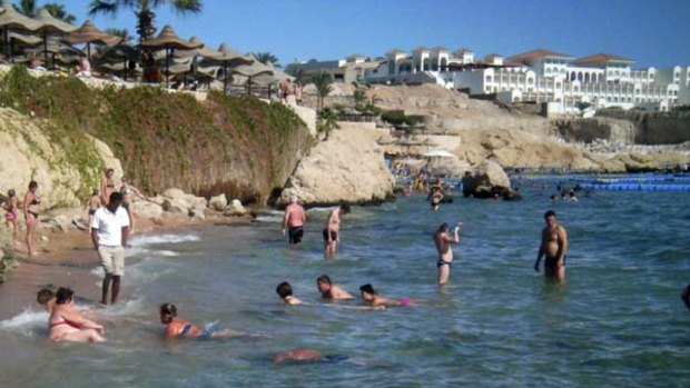 Tourists take a dip in the sea at a beach that is excluded from a swimming ban at the Red Sea resort of Sharm el-Sheikh.